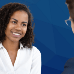 curly haired woman interview candidate shakes hand after successful interview